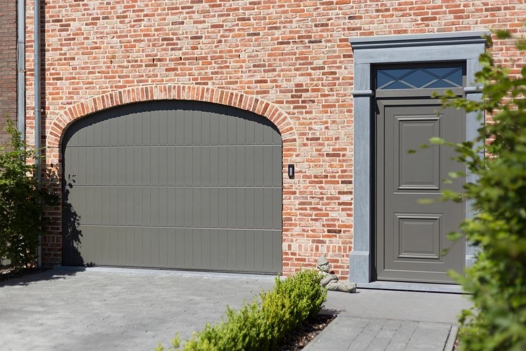 Modern brick home with a grey garage door and composite front door