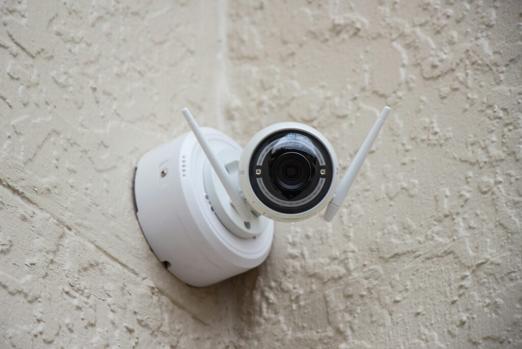 Turret CCTV camera mounted on a rendered house wall