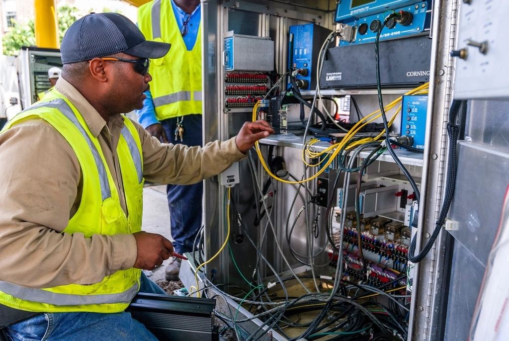 Engineer connecting cabling inside a security system cabinet