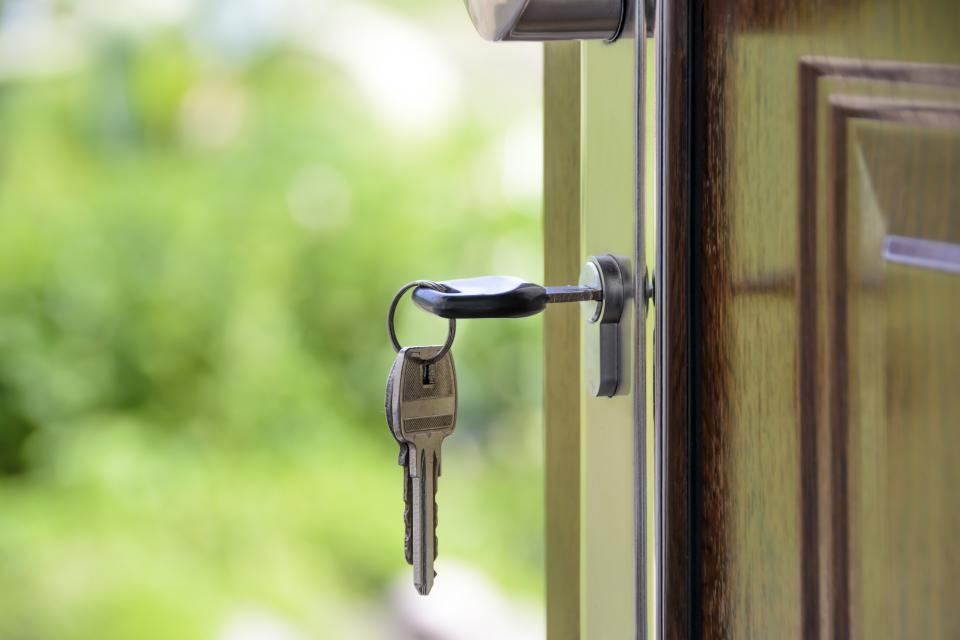 House keys left in the lock of an open front door
