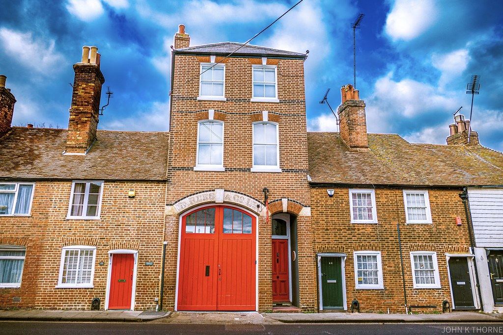 Red-brick terraced homes with colourful front doors