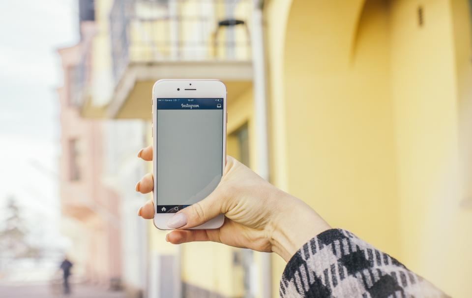 Person holding a smartphone to check an app